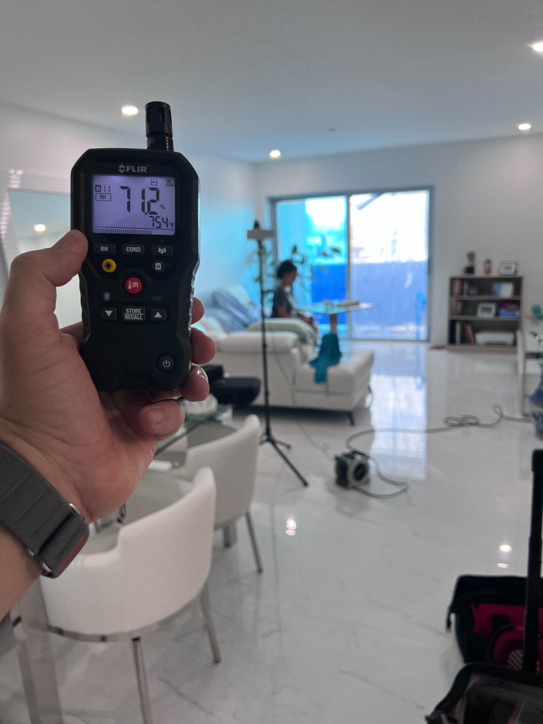 FLIR humidity meter reading during indoor air quality inspection in South Florida home