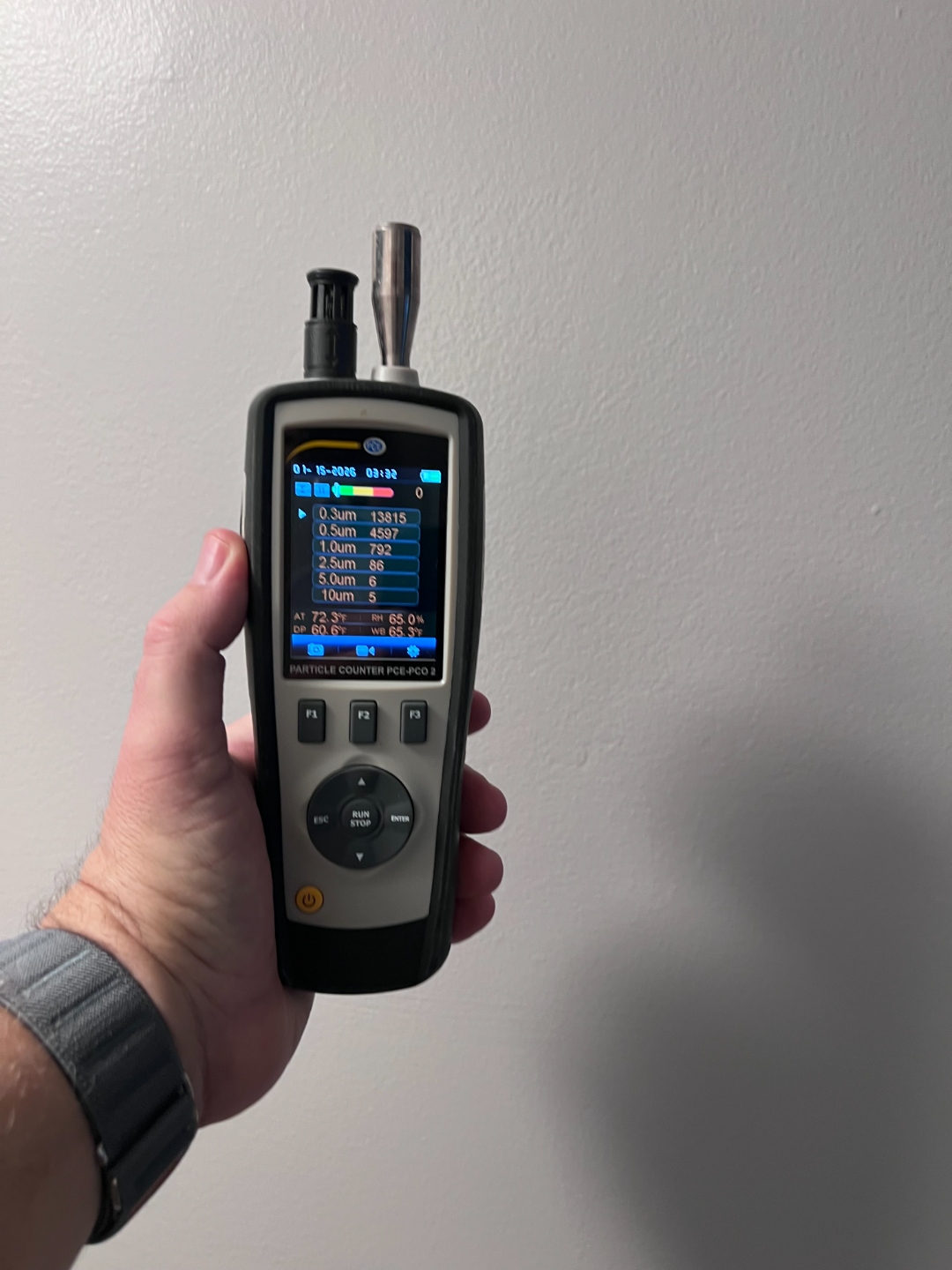 PCE-PCO 2 particle counter measuring air quality particulate levels during mold inspection