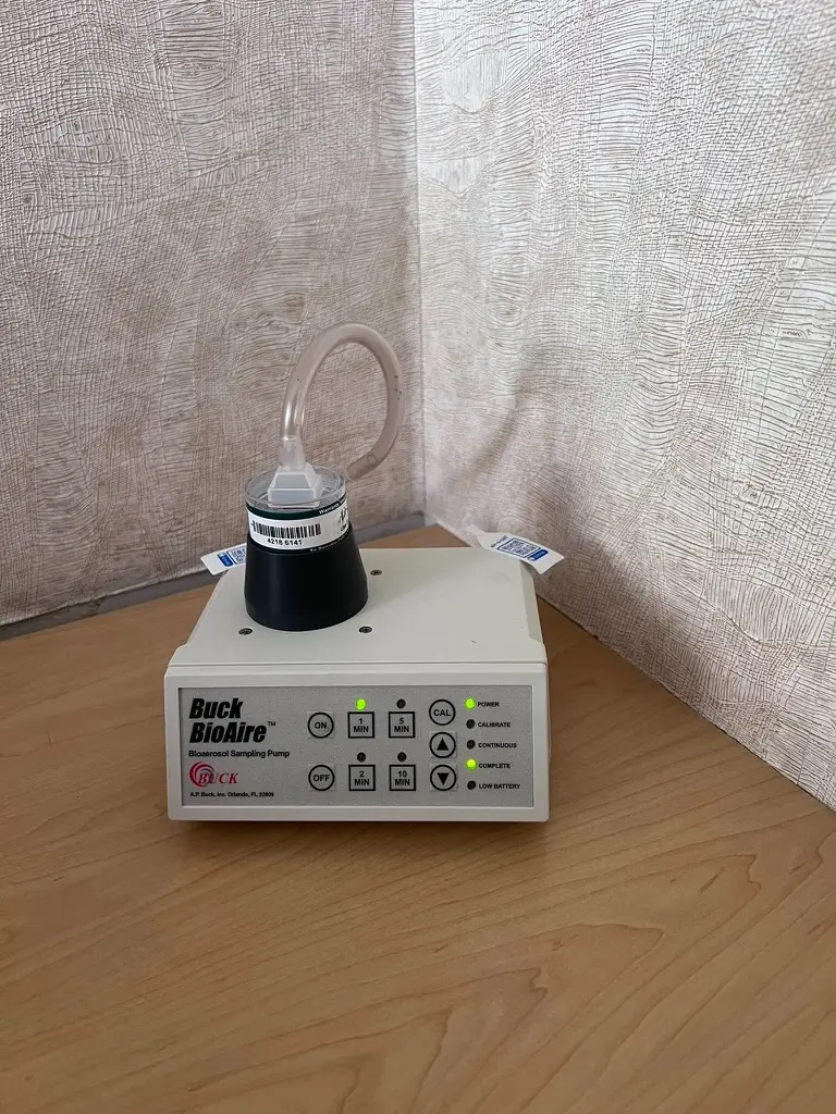 Buck BioAire calibrated bioaerosol air sampling pump with a spore trap cassette attached during a mold inspection