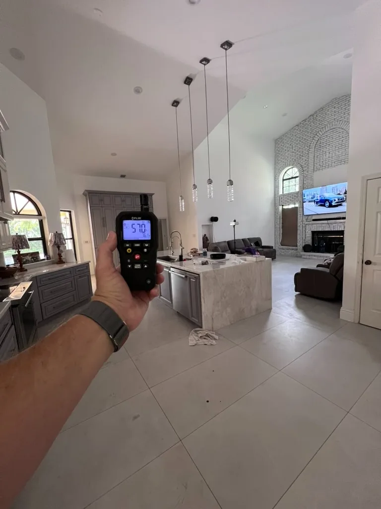 FLIR thermo-hygrometer displaying relative humidity in a vaulted great room during an indoor air quality assessment