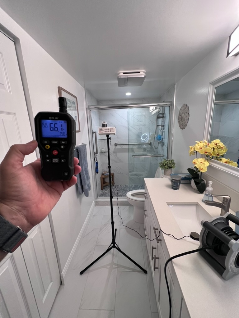 Air sample being collected in bathroom during Hialeah mold inspection