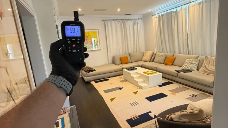 Inspector measuring indoor humidity conditions during a home inspection