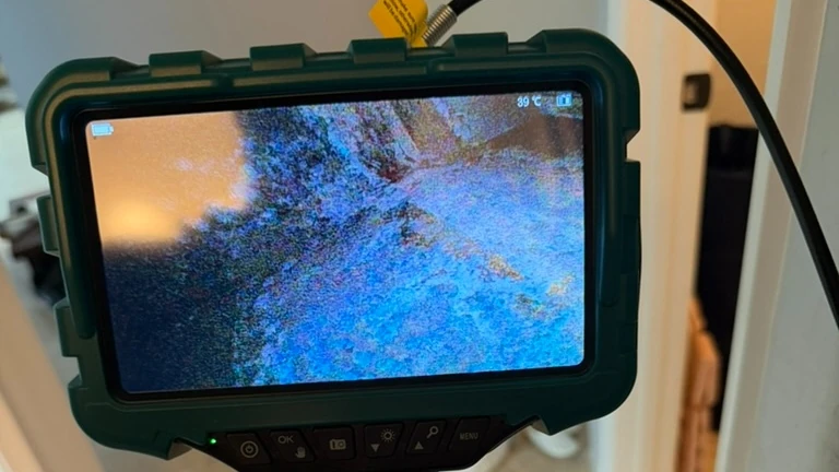 Borescope camera used to inspect a concealed building cavity