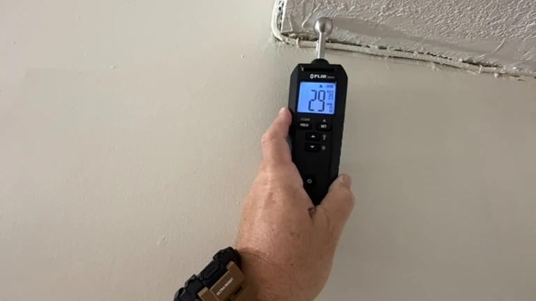Inspector evaluating a suspected moisture-affected building material