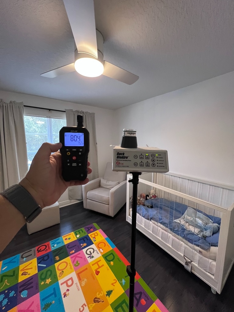 Air sampling pump and hygrometer set up in a nursery during an indoor air quality assessment