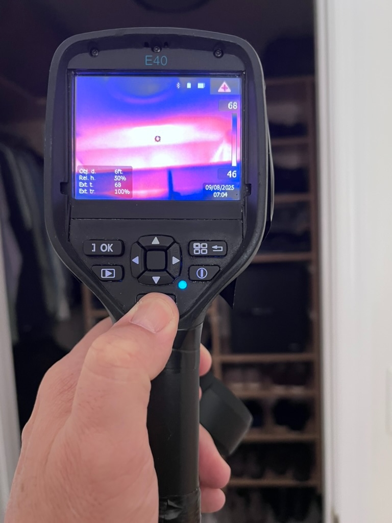FLIR E40 thermal imaging camera displaying a temperature reading of 68 degrees during a closet moisture scan