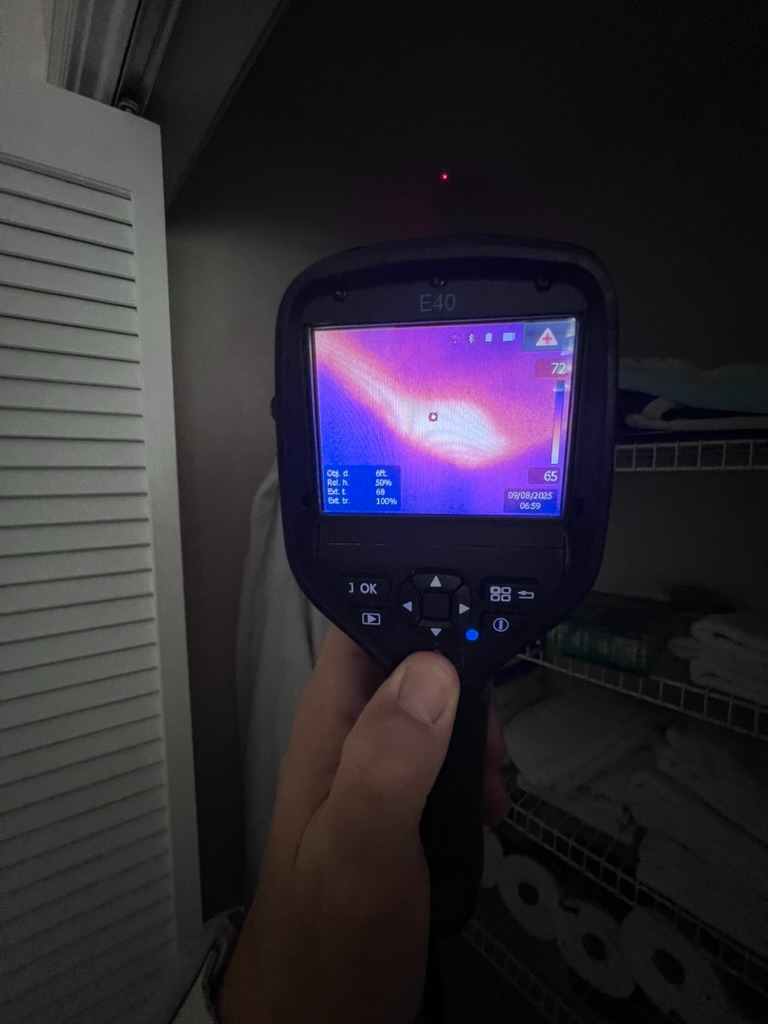 FLIR E40 thermal camera scanning inside a dark closet with shelving showing a temperature reading of 72 degrees