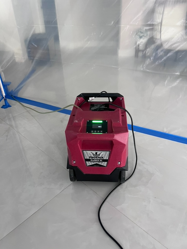 Phoenix DryMAX XL dehumidifier operating inside containment zone