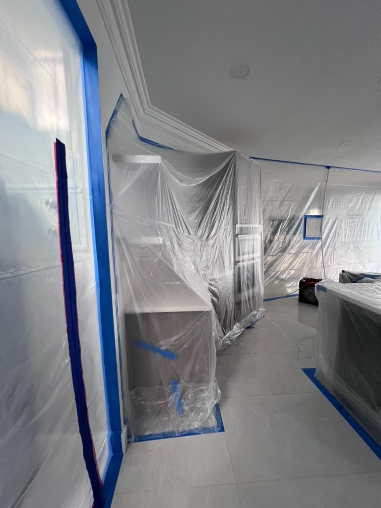 Full room containment enclosure with hallway access during remediation